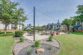 Outdoor courtyard with string lights and seating areas